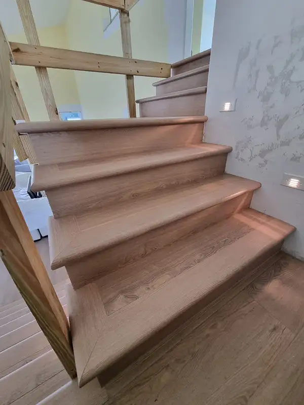 Wood stair treads being installed